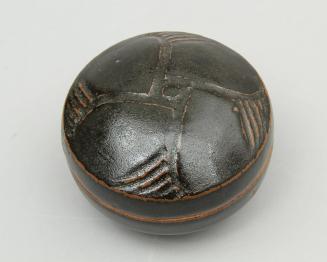 Small covered jar with carved lid