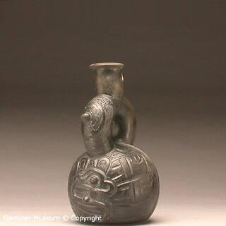 Stirrup-spout bottle with incised imagery
