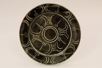 Set of eight plates with incised decoration