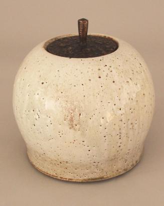 Covered jar with bronze lid, white pitted