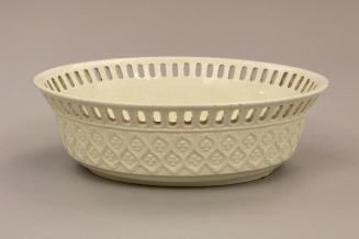 Oval fruit bowl with moulded exterior and reticulated border