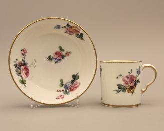 Coffee cup and saucer decorated with flowers