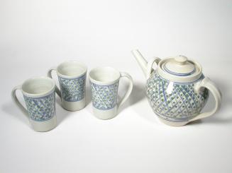 White Teapot with Blue Net and Green Spots