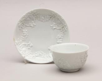 Teabowl and saucer, relief moulded