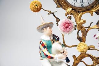 Clock with Harlequin with Bagpipes