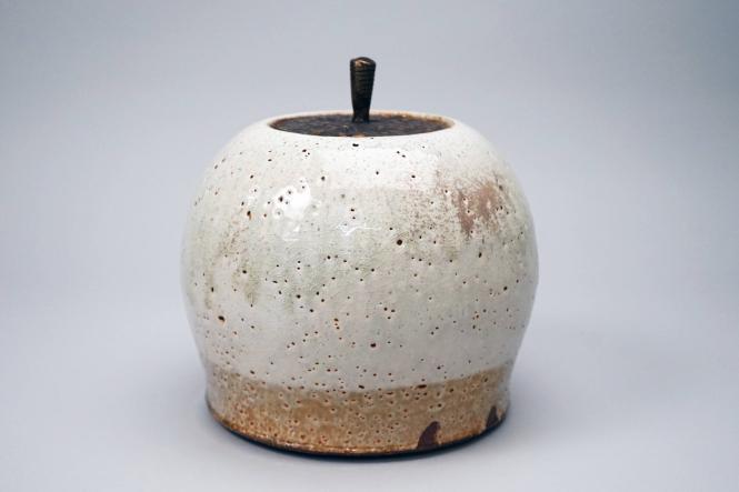 Covered jar with bronze lid, white pitted