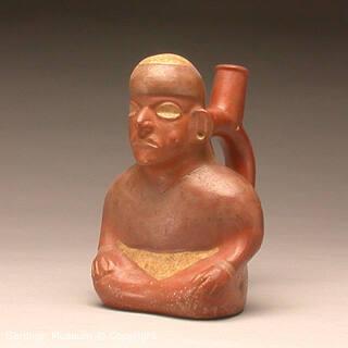 Stirrup spout bottle depicting a seated male effigy chewing coca