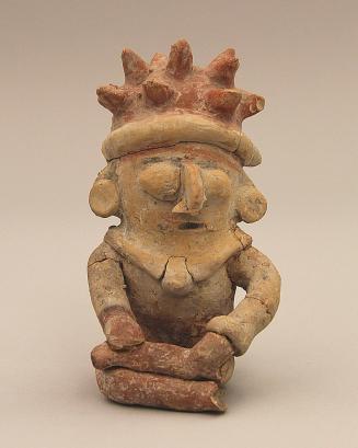 Seated figure with spiked headdress