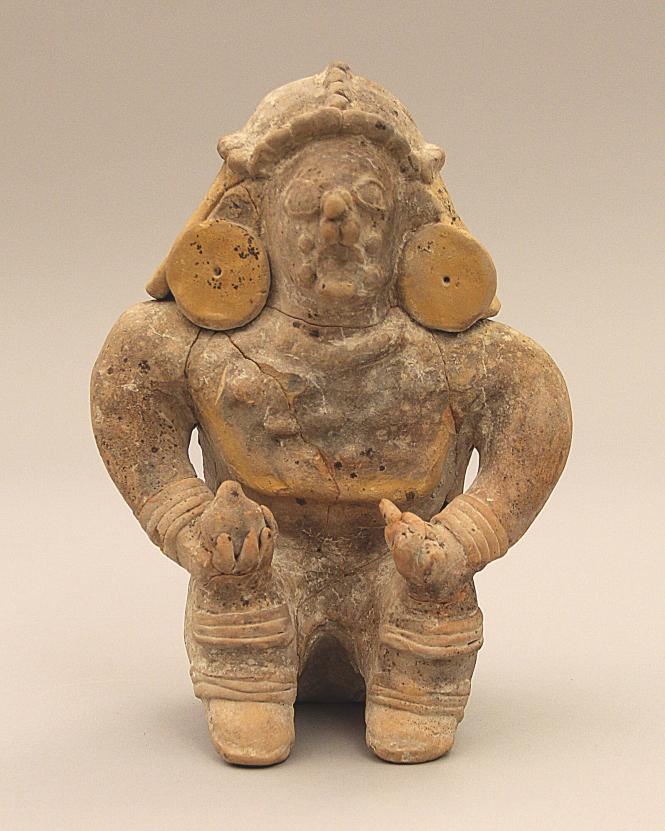 Seated figure with hands on knees